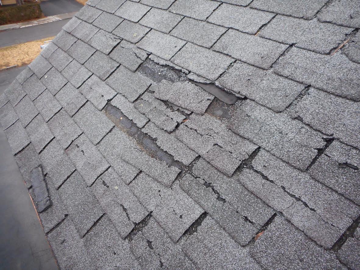 Crackled shingles with granule loss.
