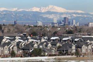 wintry homes with Rocky Mountains in background