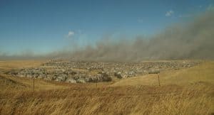 smoke on the horizon behind a Colorado town where wood shake is a popular roof material