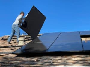 solar installers at work on a roof in Denver, CO