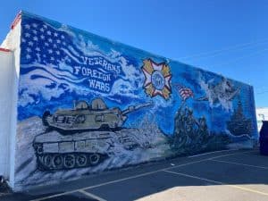 mural on the wall of VFW Post 4171 depicting a tank and American flag