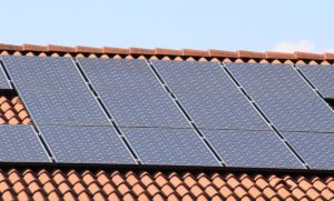an array of solar panels installed on a tile roof