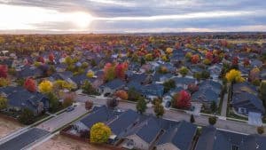 aerial shot of suburban roofs at sunset in the fall