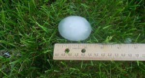 Hailstone from powerful hail storms next to ruler