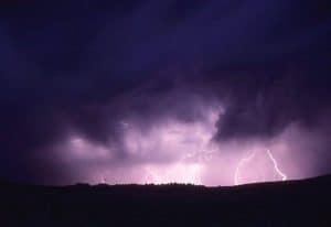Lightning striking over a dark horizon