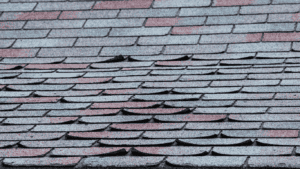 Asphalt Shingles curled from wind damage Elite Roofing & Solar in Denver, CO